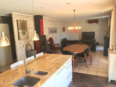 a kitchen and living room with a table and a dining room at Villa privée Un vrai havre de paix in Limoux