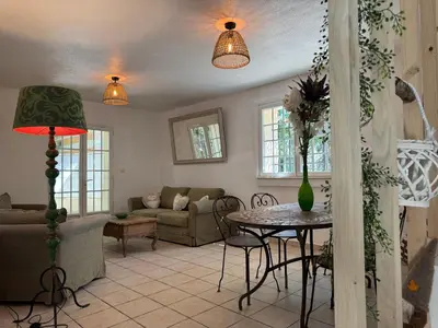 a living room with a table and a couch at chateau Laprade Narbonne in Narbonne