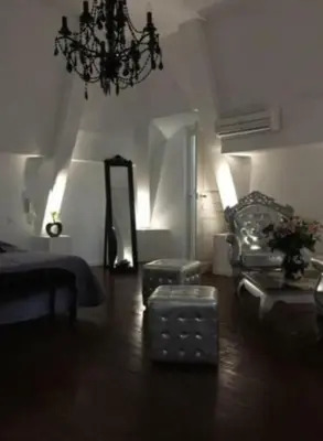 a living room with a couch and a mirror at chateau Laprade Narbonne in Narbonne