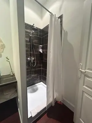 a bathroom with a shower with a shower curtain at chateau Laprade Narbonne in Narbonne