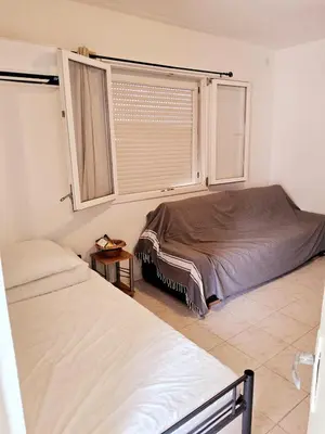 a bedroom with two beds and a window at L'anguille du port clim jardin mer in Port-la-Nouvelle