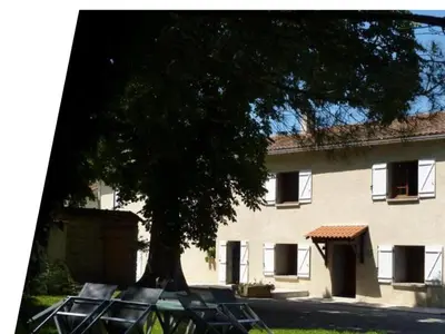 a large building with a tree in front of it at maison de campagne in Le Vernet