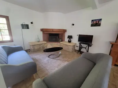 a living room with a couch and a fireplace at maison de campagne in Le Vernet