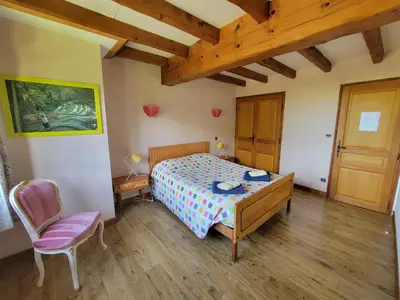 a bedroom with a bed and a table and a chair at maison de campagne in Le Vernet