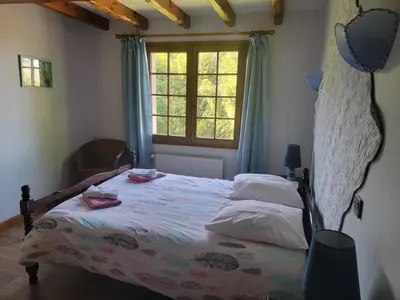 a bedroom with a bed and a window at maison de campagne in Le Vernet