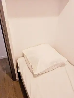 a small room with a bed with a pillow on it at L'espadon du port, air conditioning, terrace, sea, 5 people in Port-la-Nouvelle