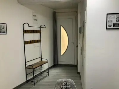 a hallway with a shelf and a door at les gites de KALY in Bélesta