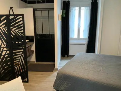 a room with a bed and a staircase and a window at les gites de KALY in Bélesta