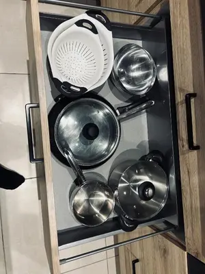 a bunch of kitchen utensils in a cabinet at David in La Tour-du-Crieu