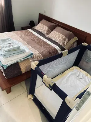 a bedroom with a bed and a baby crib at David in La Tour-du-Crieu