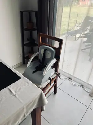 a chair with a phone in it next to a window at David in La Tour-du-Crieu