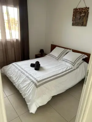a white bed with a hat on top of it at David in La Tour-du-Crieu