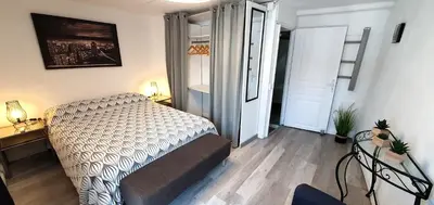 a bedroom with a bed and a door to a hallway at La Biscornutte in Thézan-des-Corbières