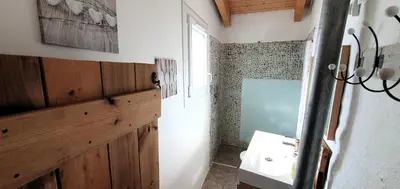a bathroom with a sink and a mirror and a window at La Biscornutte in Thézan-des-Corbières