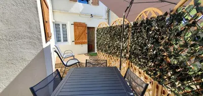 a patio with a fence with potted plants on it at La Biscornutte in Thézan-des-Corbières