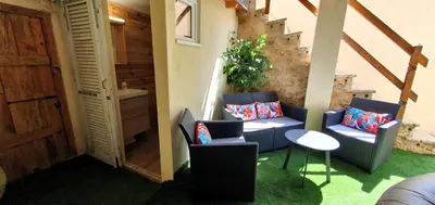 a living room with two chairs and a table at La Biscornutte in Thézan-des-Corbières