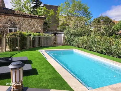 a swimming pool in the yard of a house at Gîte Coté Village - le cœur du village avec piscine in Salles-d'Aude