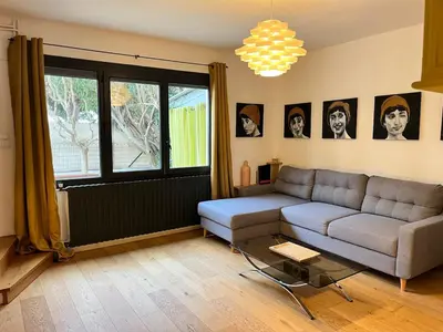 a living room with a couch and a table at Artistic house in Carcassonne