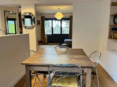 a dining room with a wooden table and chairs at Artistic house in Carcassonne