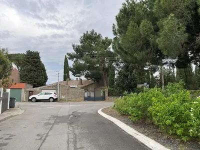 a parking lot with a car parked in a driveway at Artistic house in Carcassonne