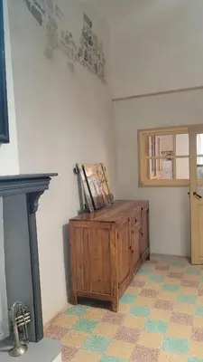 a room with a wooden cabinet with a painting on it at Peyriac de Mer House in Peyriac-de-Mer