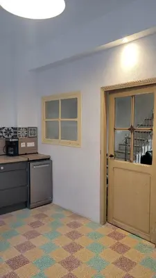 an empty room with a kitchen with a door at Peyriac de Mer House in Peyriac-de-Mer
