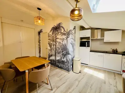 a kitchen and dining room with a table and chairs at L'escale cocoon - cozy and relaxing in Villefranche-de-Lauragais