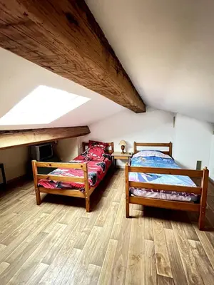 two beds in a room with a attic at Maison de village pleine de charme, 7 couchages in Vingrau