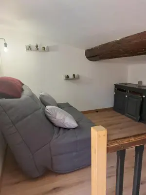 a room with a closet with hangers and a bed at L'Enclos de Nathalie et Jacques in Rieux-Minervois