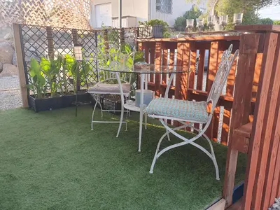 a patio with a table and chairs and a fence at Insinuances in Douzens