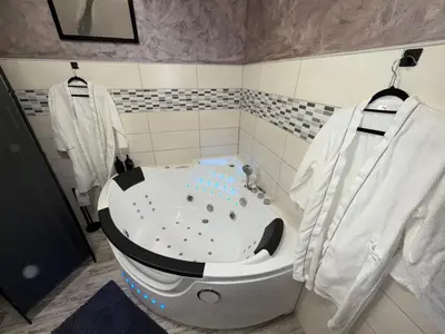 a bathroom with a bath tub in a room at Insinuances in Douzens