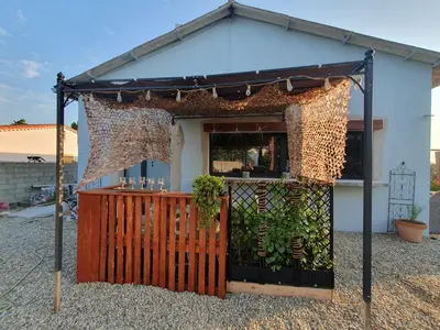 a building with a fence and a bar in it at Insinuances in Douzens