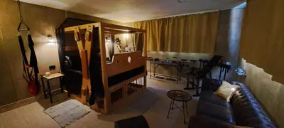 a living room with a couch and a mirror at Insinuances in Douzens