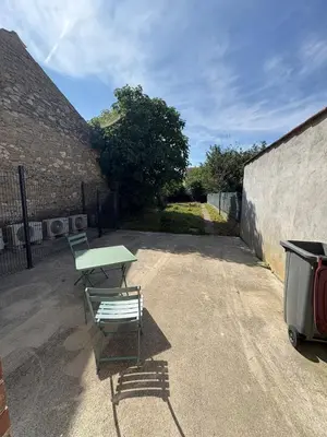 a picnic table and a bench in a parking lot at Albert I Ground floor l Terrace l Garden l Air conditioning in Castres