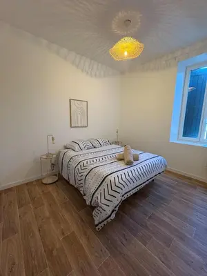a bedroom with a bed with a stuffed animal on it at Albert I Ground floor l Terrace l Garden l Air conditioning in Castres