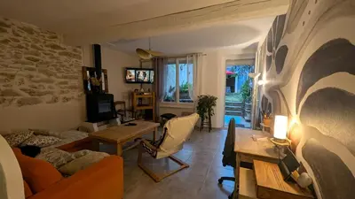 a living room with a couch and a table at Le Nid de Marguerite in Castelnaudary