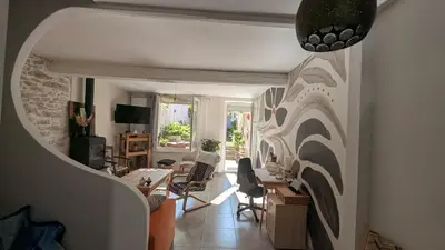 a living room with a table and chairs at Le Nid de Marguerite in Castelnaudary