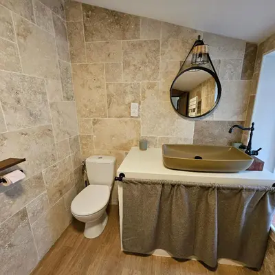 a bathroom with a sink and a toilet and a mirror at Domaine VILLECARLA, Gîte 2 Canal du Midi Carcassonne in Villedubert