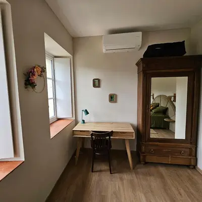 a small room with a table and a mirror at Domaine VILLECARLA, Gîte 2 Canal du Midi Carcassonne in Villedubert