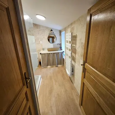 a hallway of a bathroom with a sink and a door at Domaine VILLECARLA, Gîte 2 Canal du Midi Carcassonne in Villedubert