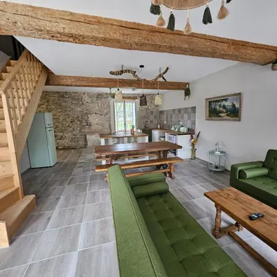 a large living room with wooden ceilings and green furniture at Domaine VILLECARLA, Gîte 2 Canal du Midi Carcassonne in Villedubert