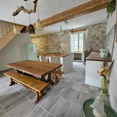 a kitchen and dining room with a wooden table and bench at Domaine VILLECARLA, Gîte 2 Canal du Midi Carcassonne in Villedubert