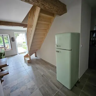 a kitchen with a refrigerator and a staircase at Domaine VILLECARLA, Gîte 2 Canal du Midi Carcassonne in Villedubert