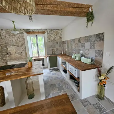 a kitchen with a wooden counter in a room at Domaine VILLECARLA, Gîte 2 Canal du Midi Carcassonne in Villedubert