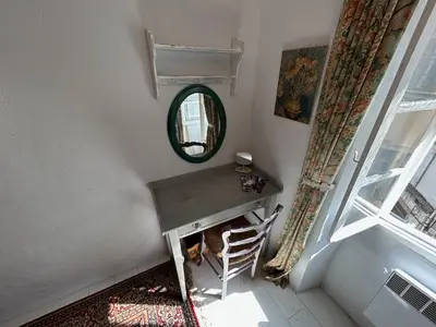 a room with a table and a mirror and a chair at Tout Le Monde in Quillan