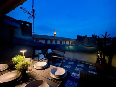 a group of toilets sitting on a balcony at night at The Artist's House Limoux in Limoux