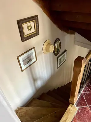 a stairway with pictures on the wall and a stair case at The Artist's House Limoux in Limoux
