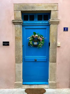 a blue door with a wreath on it at The Artist's House Limoux in Limoux