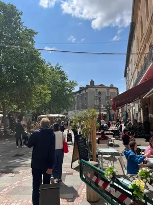 a group of people walking down a city street at The Artist's House Limoux in Limoux