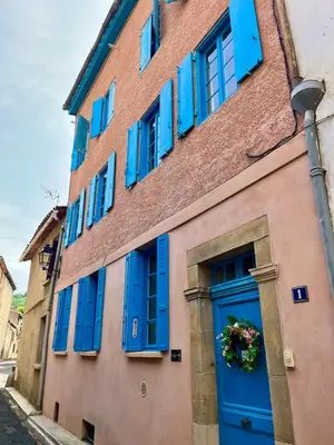 a building with blue windows and a blue door at The Artist's House Limoux in Limoux